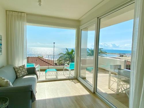 a living room with a couch and a view of the ocean at Via Firenze 11 in Follonica