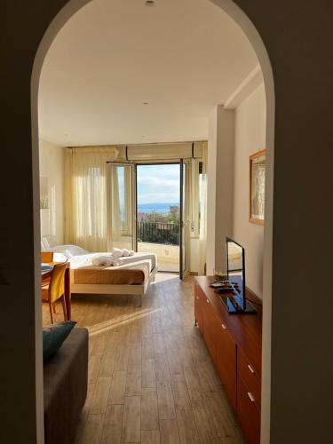 a bedroom with a bed and a large window at Casetta Limonella in Taormina