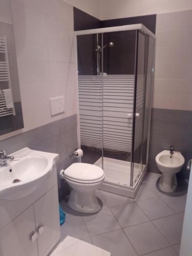 a bathroom with a shower and a toilet and a sink at InBlu in Bari