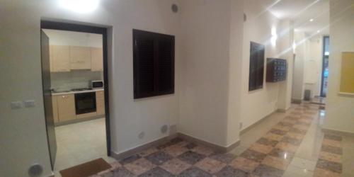 a kitchen with white walls and a large doorway at InBlu in Bari
