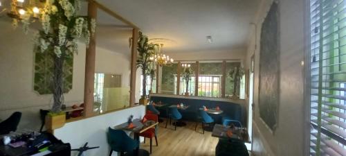 a restaurant with blue chairs and tables in a room at Royal Sportsman Hotel in Porthmadog