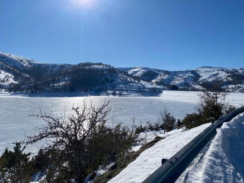 a view of a lake with snow on the ground at Casa vacanze Lago di Campotosto in Campotosto