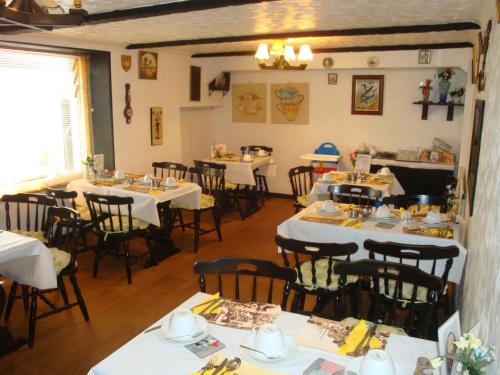 a restaurant with tables and chairs in a room at Spencer Court in Ramsgate