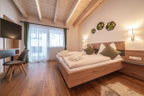 a bedroom with a bed and a large window at Mein Gaisberg in Obergurgl