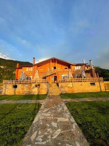 a large brick building with a pathway in front of it at Resort Mezini in Ersekë
