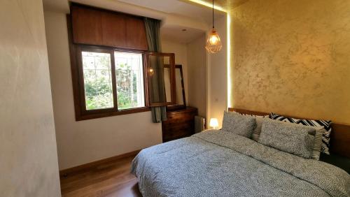 a bedroom with a bed and a window at Luxury Family House with Garden View Casablanca in Casablanca