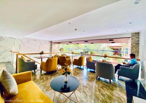 a person sitting at a table in a waiting room at SWEDEN HOTEL and APARTMENT in Da Nang