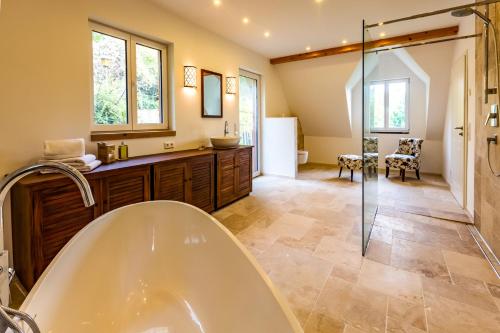 a bathroom with a tub and a walk in shower at Hohenlohe Hideaway in Langenburg