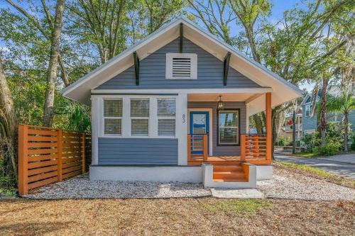 a small blue tiny house with a wooden fence at Relaxing Retreat and Modern Charm in Historic Saint Augustine in St. Augustine