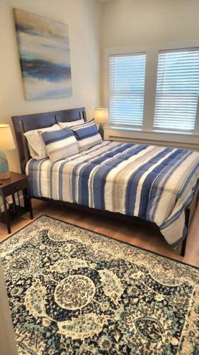 a bedroom with a bed and a rug at Relaxing Retreat and Modern Charm in Historic Saint Augustine in St. Augustine