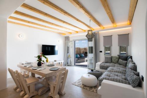a living room with a table and a couch at Mykonos Village in Ano Mera