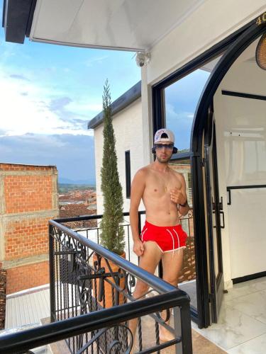 a man in red underwear standing on a balcony at Heinz B. in Santa Ana de los Caballeros