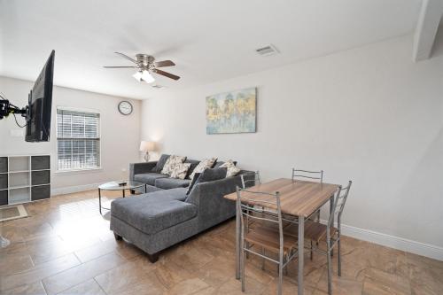 a living room with a couch and a table at Pristine & Exquisitely Designed APT 7 Min From TX Med Center in Houston