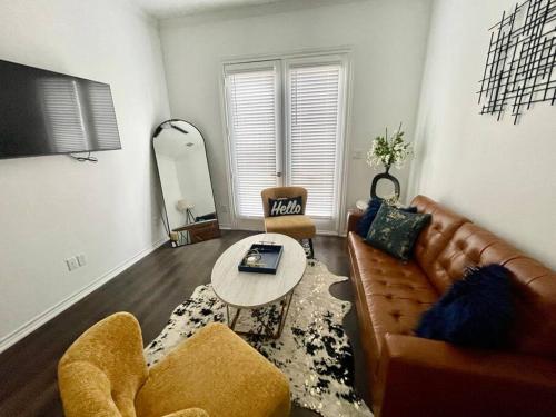 a living room with a couch and a table at Chic Urban Living Minutes from I-45 and I-610 #A in Houston