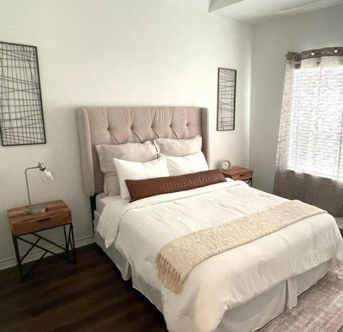 a bedroom with a large bed with a large headboard at Chic Urban Living Minutes from I-45 and I-610 #A in Houston
