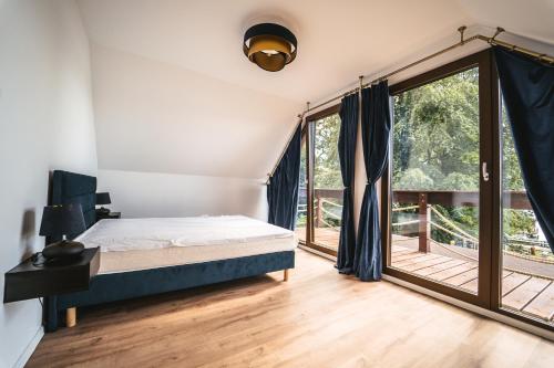 a bedroom with a bed and a large window at Urocza Przystań Siecino in Siecino