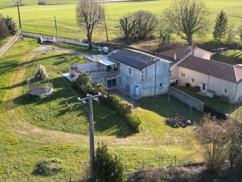 an aerial view of a house in a field at Authentique maison en pierre de 160 m2 au calme in Reignac