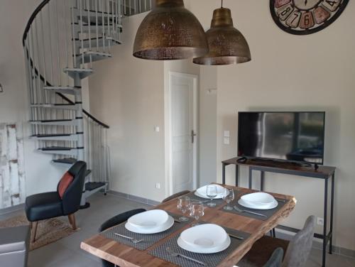 comedor con mesa de madera y sillas en Gîte Le Mas de Molines, en Vogüé