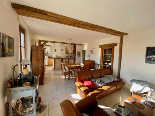 a living room with a couch and a table at Maison 5 chambres à Lamotte, entre canal et centre équestre in Lamotte-Beuvron