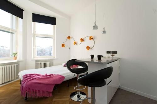 a bedroom with a bed with a desk and a chair at Stylish studio in the centre in Helsinki