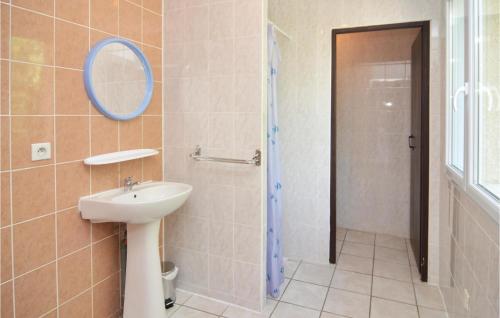 a bathroom with a sink and a mirror and a shower at Beautiful Home In Courry With Kitchen in Courry