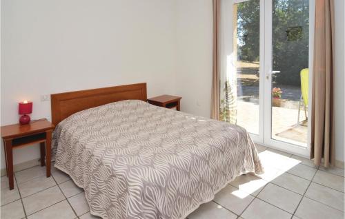 a bedroom with a bed and a sliding glass door at Beautiful Home In Courry With Kitchen in Courry
