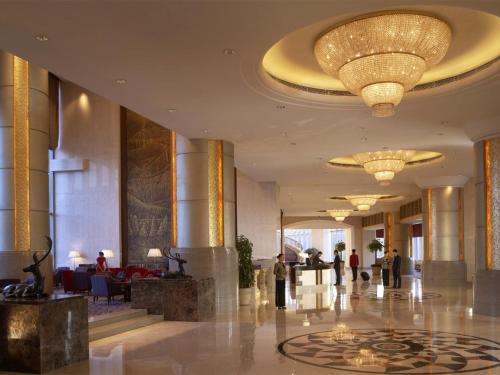 a lobby of a hotel with a large chandelier at Shangri-La Baotou in Baotou