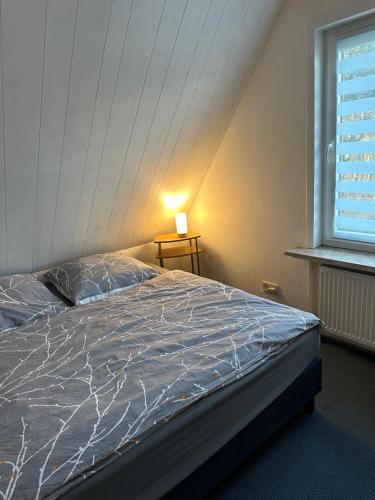Bett in einem Zimmer mit Fenster in der Unterkunft Apartment Haus Julia in Norderney