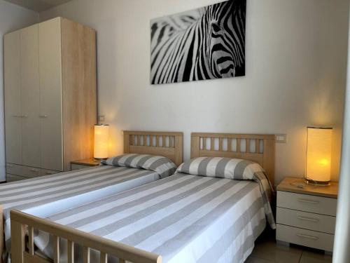 Ένα ή περισσότερα κρεβάτια σε δωμάτιο στο Appartamento Verdi, a 100 metri dal mare.