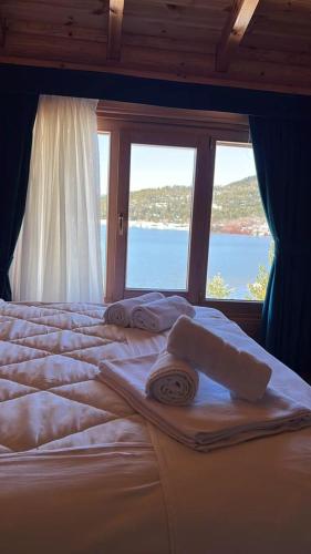 a bedroom with a bed with a large window at Resort Mezini in Ersekë