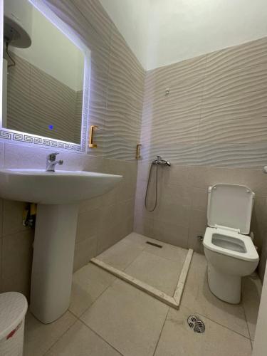 a bathroom with a sink and a toilet at Westwood 2Bd Apartments in Durrës