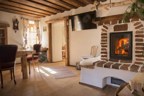 a living room with a fireplace and a table at Baumgartner - Bauernhaus in Weißkirchen in Steiermark