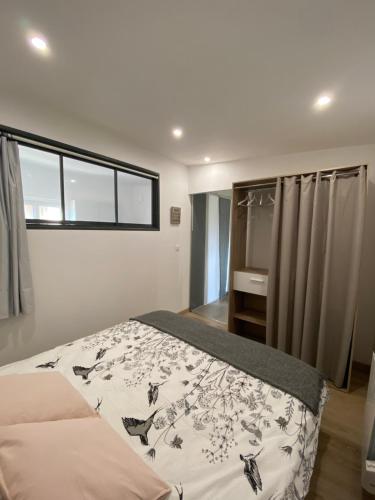 a bedroom with a bed and a window at Maisonnette cosy à 10 mn de Nantes in Rezé