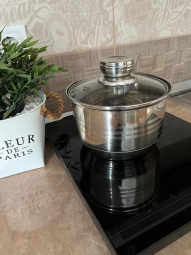 a metal pot sitting on top of a stove at Silver Apartman in Eger