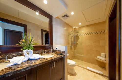 a bathroom with a sink and a toilet and a shower at 360 Splendor Del Pacifico Residences in Playa Flamingo