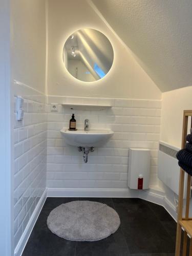 a bathroom with a sink and a mirror at Ferienwohnung in Bad Bramstedt in Bad Bramstedt