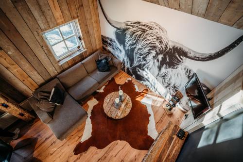 an overhead view of a living room with an elephant painting on the wall at Logement Bilderdam in Leimuiden