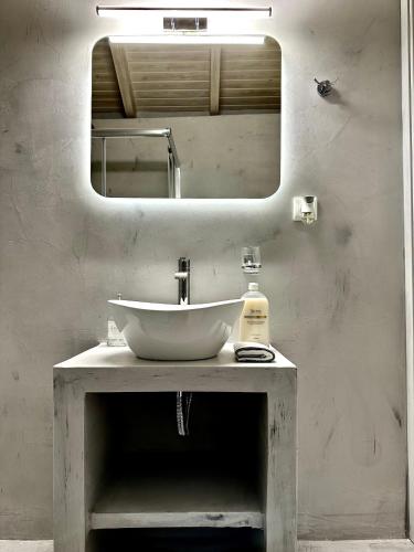 a bathroom with a sink and a mirror at WoodHome in Kalamitsi