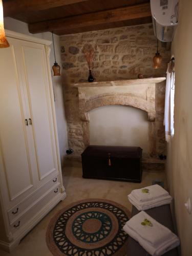 a room with a stone wall and a door and a rug at Casa Opuntia in Pappayiannádhes