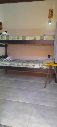 a couple of bunk beds in a room at Sitio148 Hospedaria in Penedo