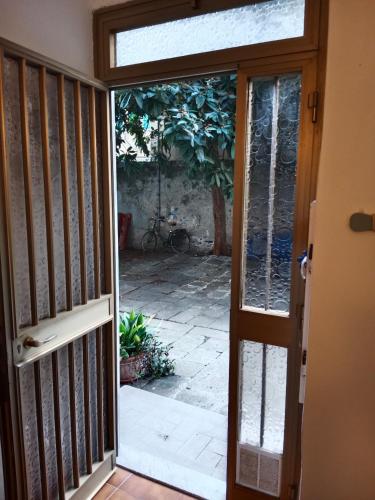 an open door with a view of a courtyard at MOLO 37 in La Spezia