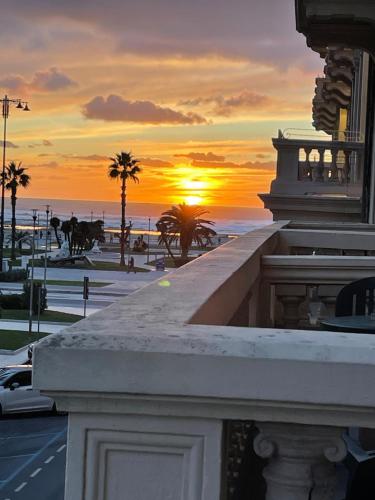 a sunset over the ocean from the balcony of a building at Hotel Lukas Vegetarian & Vegan in Viareggio