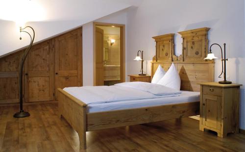 a bedroom with a large bed with wooden cabinets at Landgasthof zu den drei Sternen in Brunegg