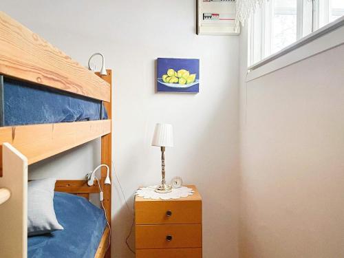 a bedroom with a bunk bed and a lamp on a night stand at Holiday home KORSBERGA II in Korsberga