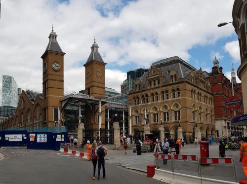 a city street with a clock tower and buildings at The AA WIFI in London