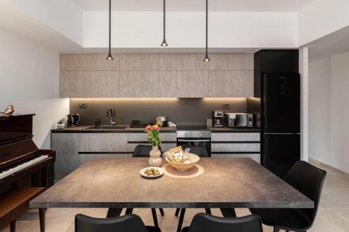 a kitchen with a dining table and a piano at Chania City Luxury Dreams Apartment in the Heart of Chania in Chania