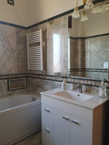 a bathroom with a sink and a tub and a mirror at Mare qui in Gaeta