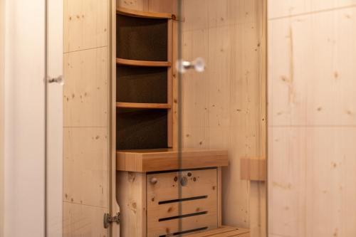 a wooden cabinet with wooden shelves in a room at Mein Gaisberg in Obergurgl