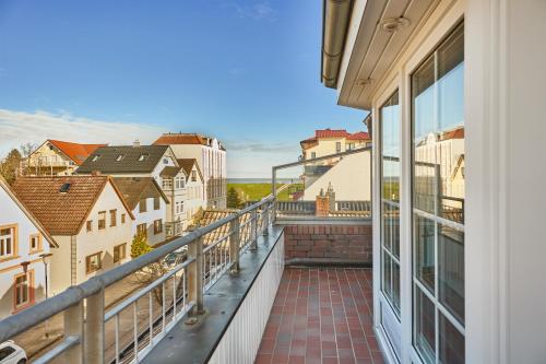 a balcony with a view of a city at Ferienwohnung mit Seesicht Grimmershörnbucht in Cuxhaven