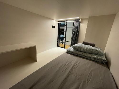 a bed in a room with a window at Sleep&Go Hostel Ljubljana in Ljubljana